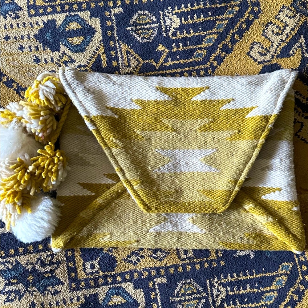 Anthropologie Envelope Clutch w/pompoms. Aztec print in Cream/Yellow.